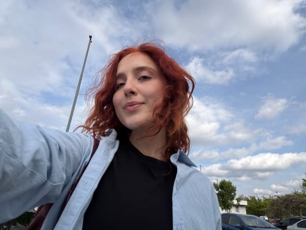 Person captures casual selfies with orange flower in Tbilisi