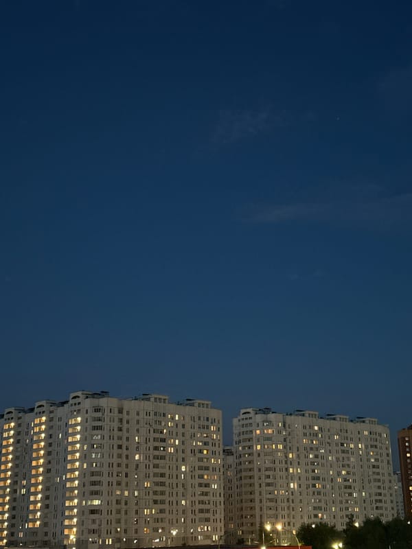 Podolsk residential towers lit up at dusk