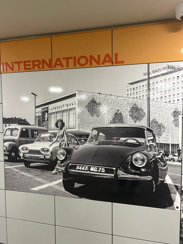 Berlin transit station displays international signage, tango concert poster