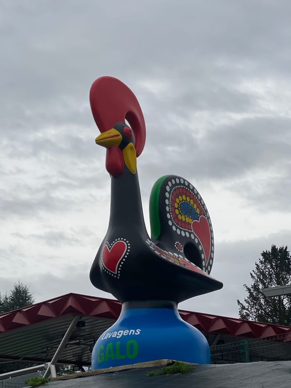 Tourists document famous Barcelos rooster statue in Portugal