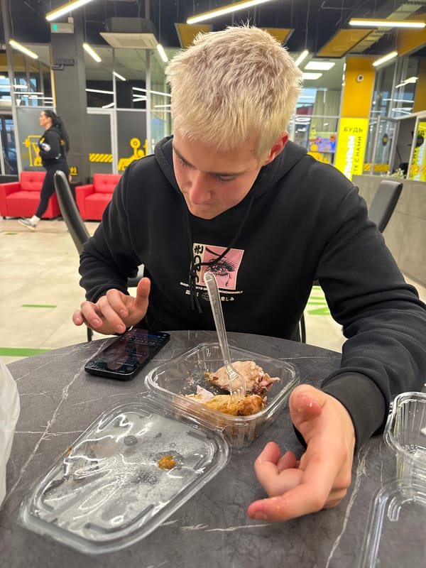 Young person in black hoodie observed at indoor table