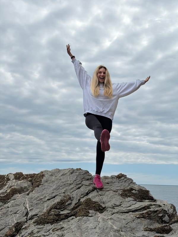 Woman poses on Budva cliffs during Adriatic coastal visit