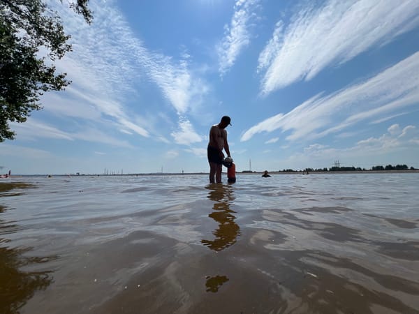 Casual summer wading at a shallow shoreline in Noviy, Russia