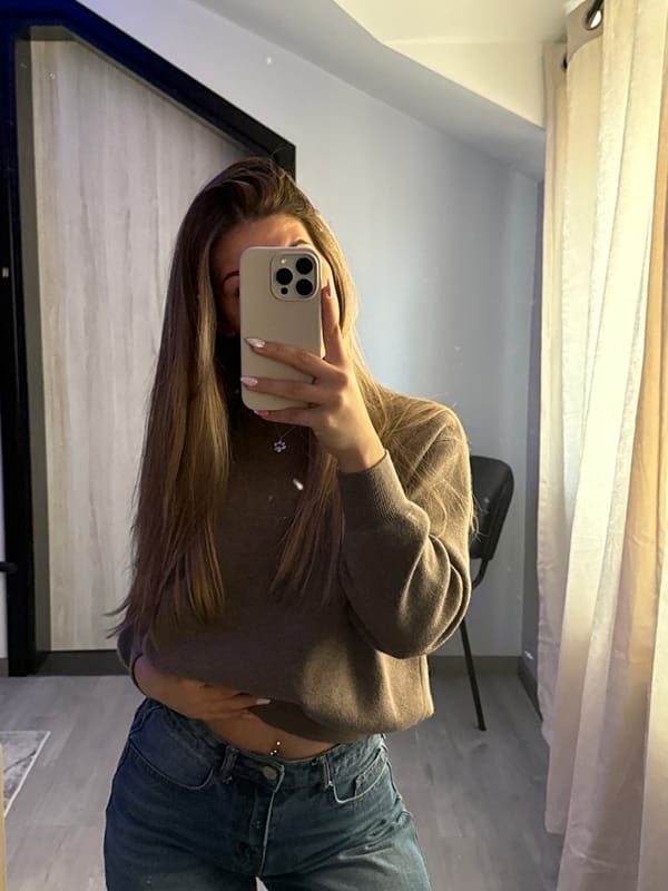 Woman takes mirror selfie at home in Bulgaria