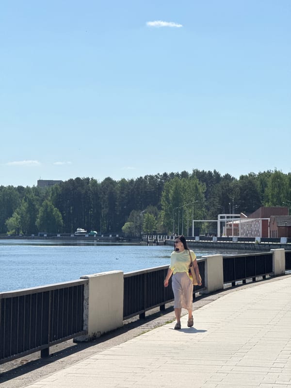 Morning stroll captured along waterfront promenade with mermaid sculptures