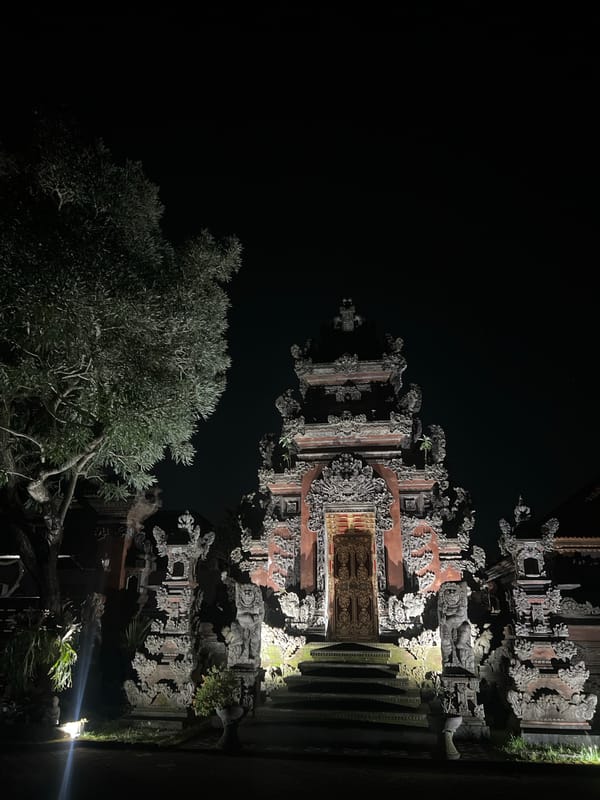 Traditional carved Balinese structure documented at night in Blahbatuh