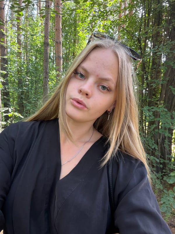 Selfie session among pine trees near a construction site in Izhevsk