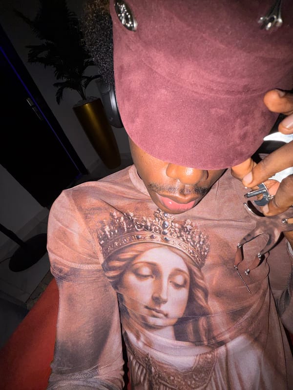 Person in crowned figure shirt, maroon beret spotted in Nigeria