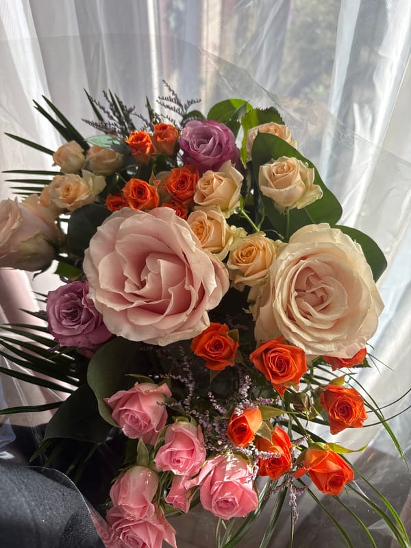 Colorful rose bouquet spotted by window in Veghel