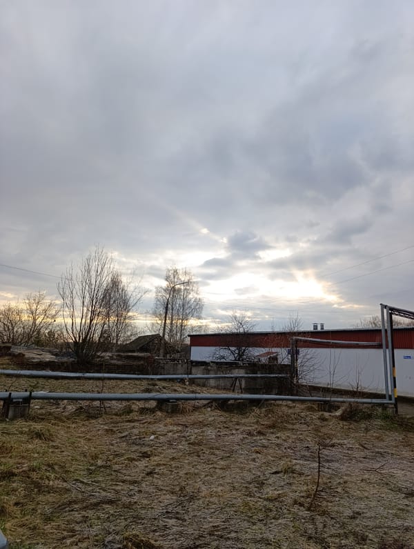 Woman photographed under overcast spring sky in rural Russia