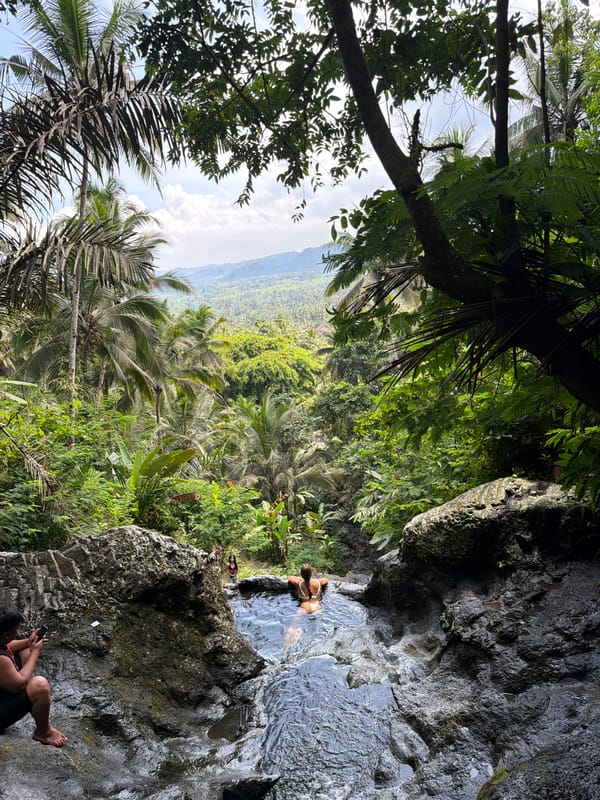 Tourist documents scenic stairway descent to natural pool in Sidemen