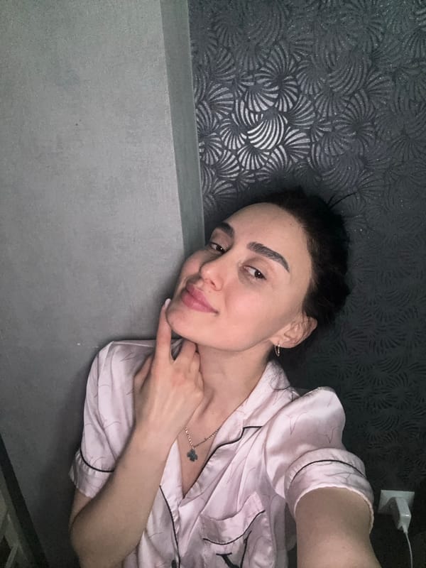 Person in pink pajamas resting indoors in Tbilisi