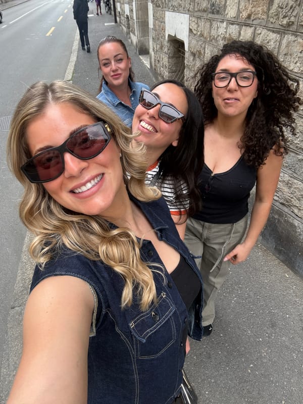 Women pose for group selfie on Geneva street