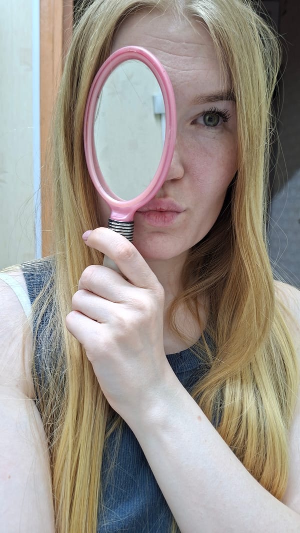 Woman poses with pink mirror in Russian home