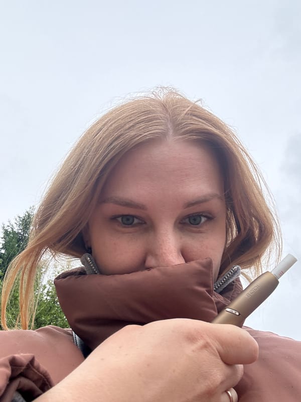 Woman takes selfies with IQOS device in Yaroslavl