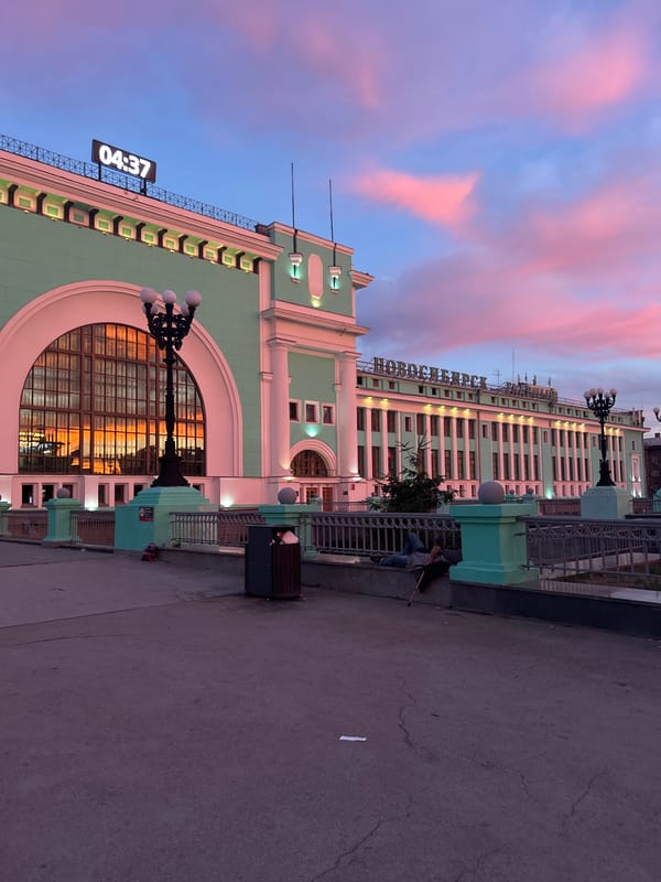 Vivid dusk sky over an urban street, clock tower visible