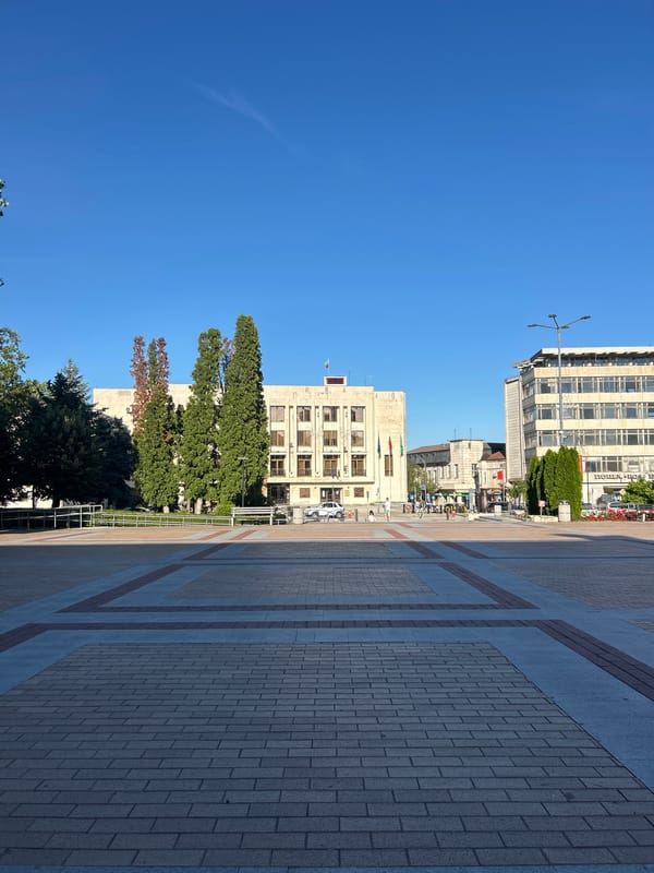 Afternoon in a sunny city square with cafés and cold drinks