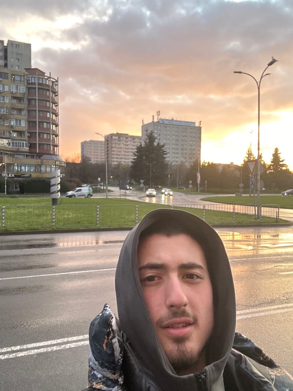 Man takes selfie on wet street during sunset in Burgas