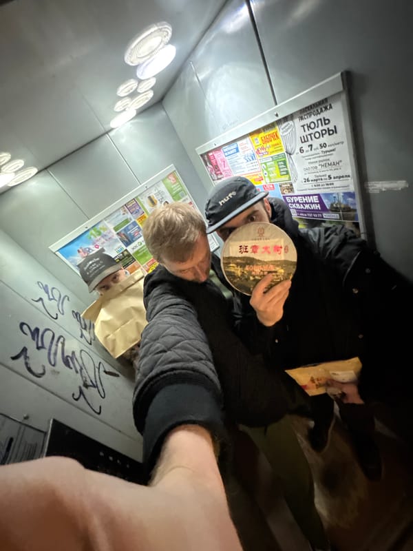 Two people in advertisement-covered enclosed space in Hrodna