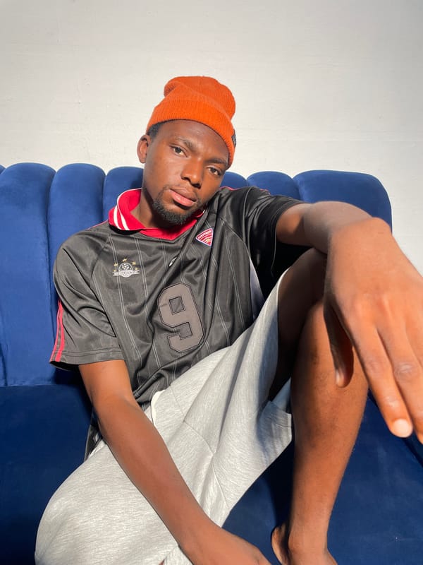 Man in orange beanie observed resting indoors in Nigeria