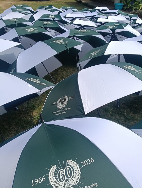 Dozens of umbrellas scattered across grassy area in Nairobi