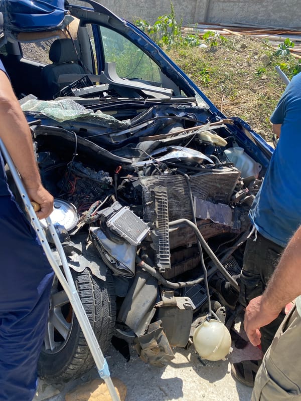 Severely damaged blue van documented at Baraki salvage yard