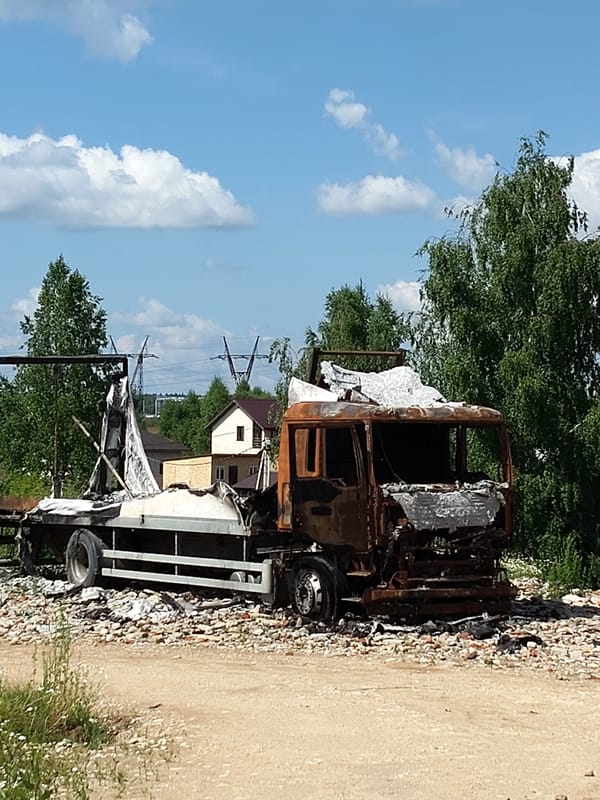 Burned truck and calm surroundings in Chekhov, Russia