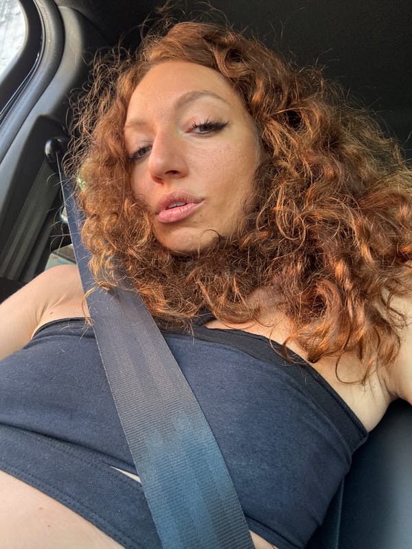 Woman displays wistful expression in vehicle, Sa Pa Ward