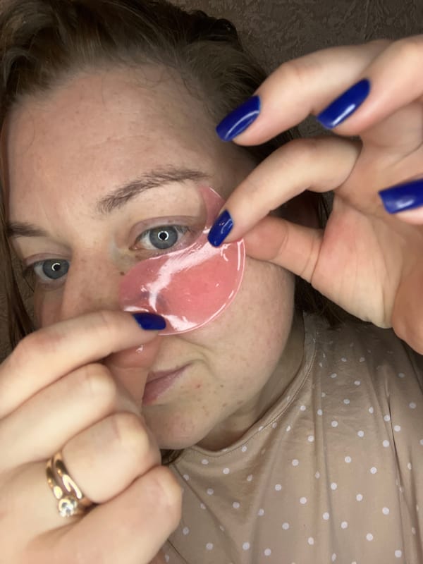 Woman applies beauty patches, rests in fairy-lit room