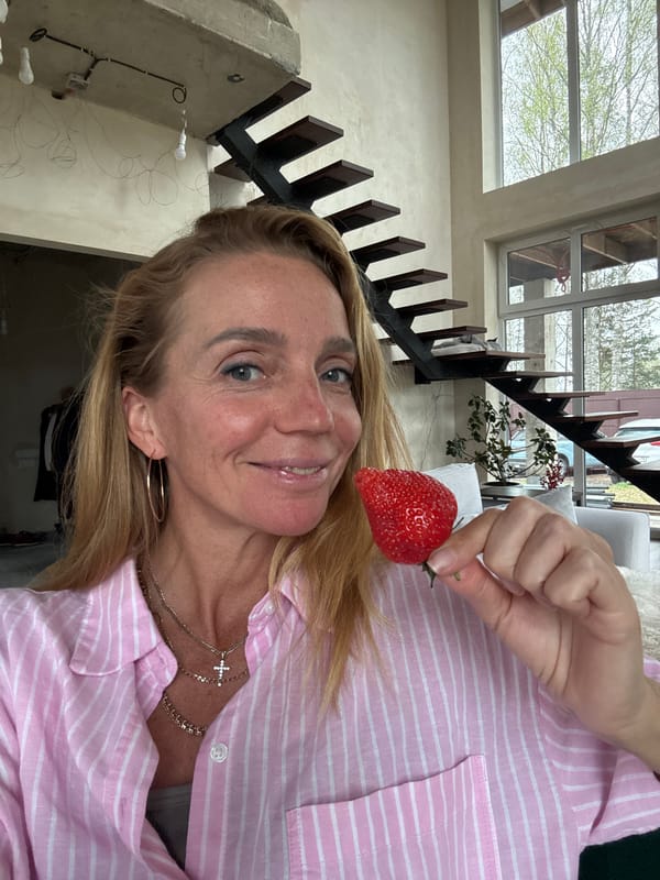 Woman with strawberry, Siamese cat captured in Russian home