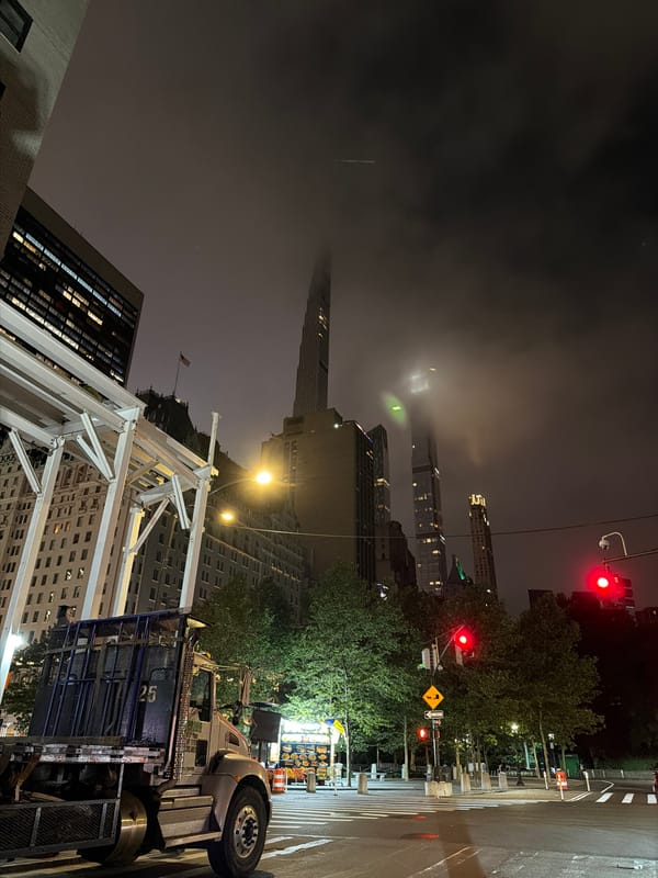 Lumber-loaded flatbed truck parked on NYC street at night