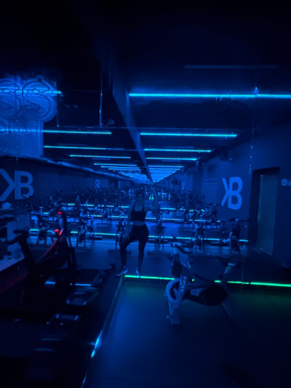 Neon-lit cycling class captured at Puebla fitness studio