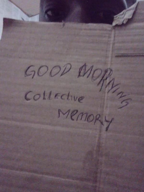 Person displays handwritten Collective Memory signs in Akwete Nigeria