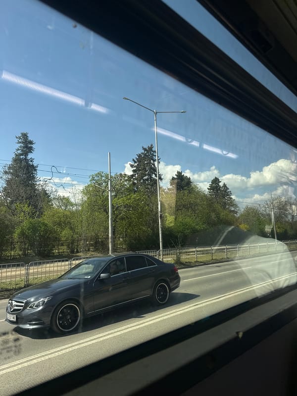 Transit passenger captures Sofia street scene through vehicle window