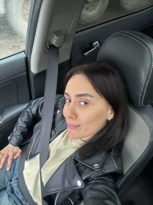 Woman takes car selfies in Tbilisi vehicle