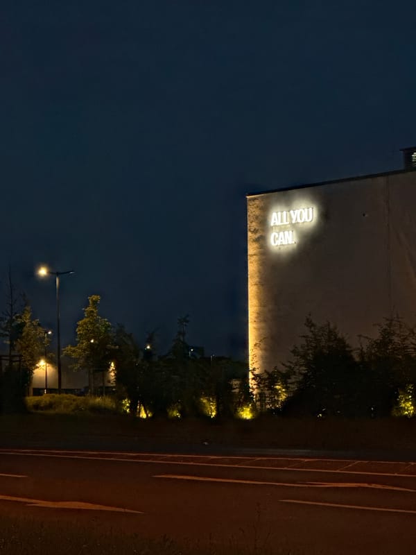 Neon-lit building at dusk, Krefeld roadside, June evening