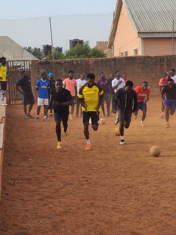 Soccer team practices on urban dirt field