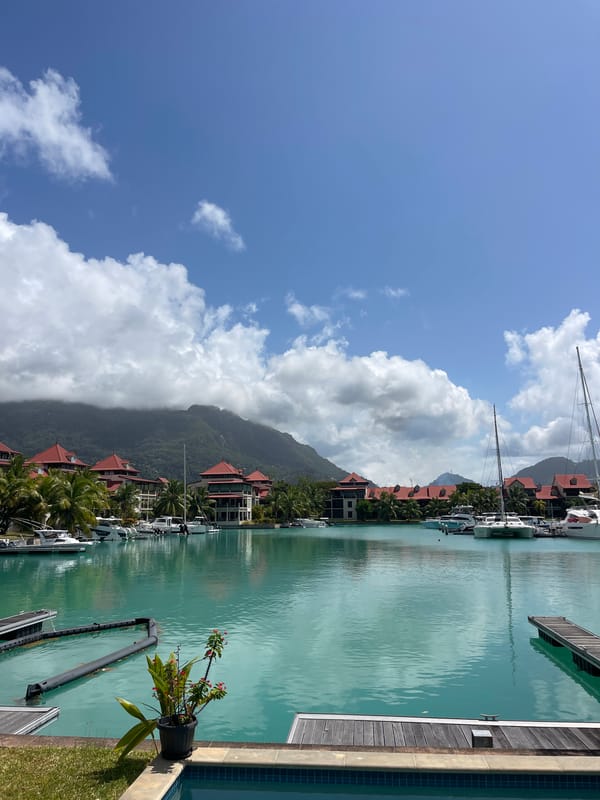 Poolside views of Victoria's marina with mountain backdrop