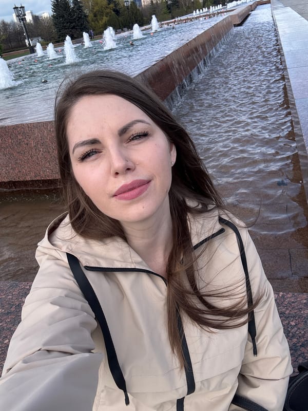 Woman photographed at Moscow Victory Park fountain amid cloudy skies