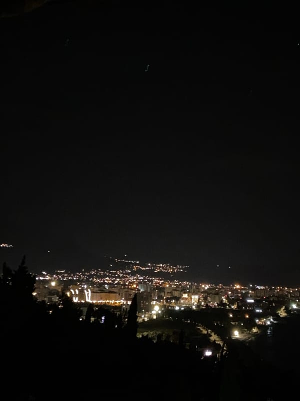 Nighttime cityscape view captured from elevated perspective in Šušanj