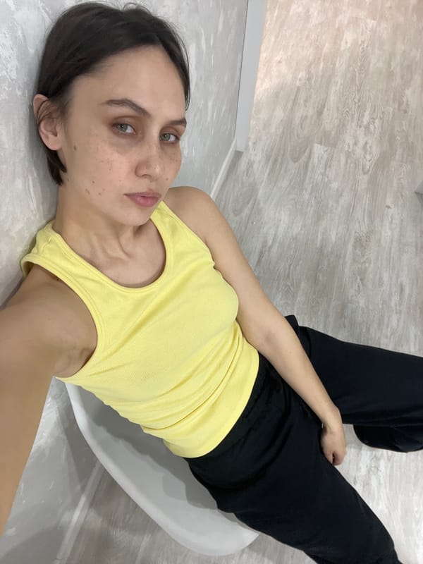 Woman rests on white chair in Izhevsk home