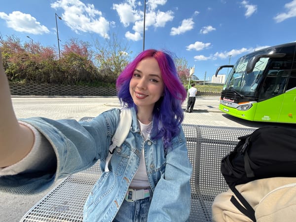 Woman takes colorful hair selfies at Budapest tram station