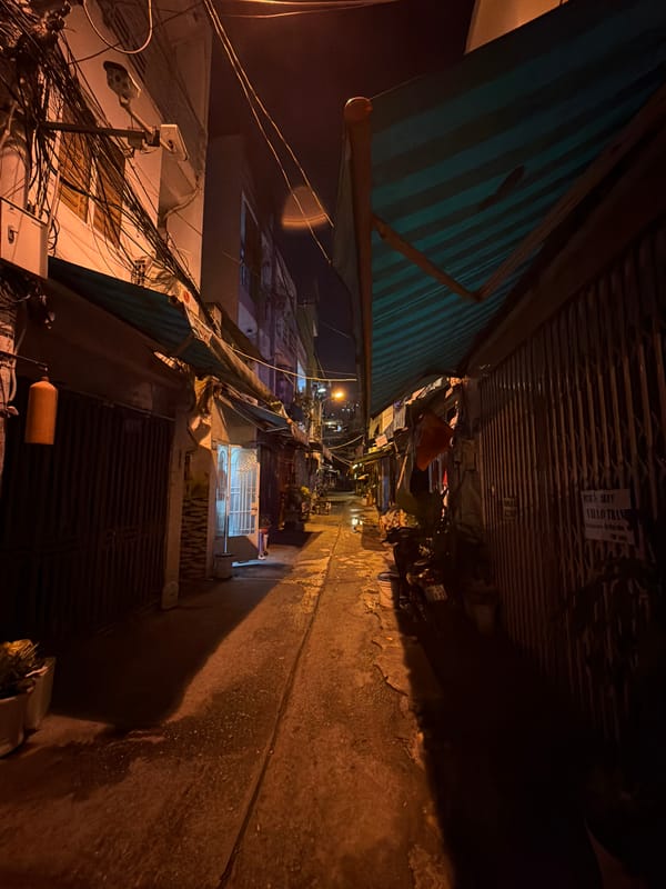 Night Documentation of Wet Streets and Illuminated Buildings in Thủ Đức