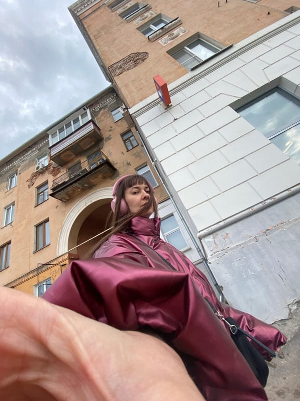 Person takes selfies in maroon jacket, pink headphones in Votkinsk