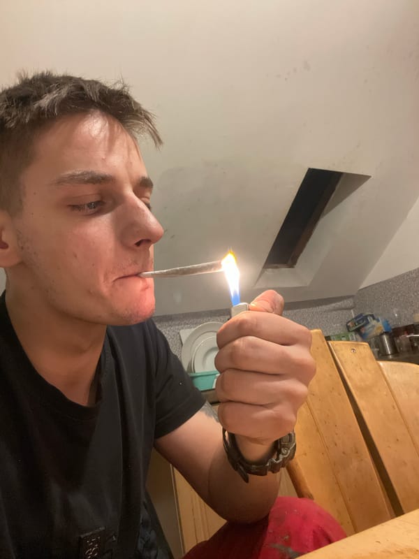 Young man cooks and takes selfies in kitchen