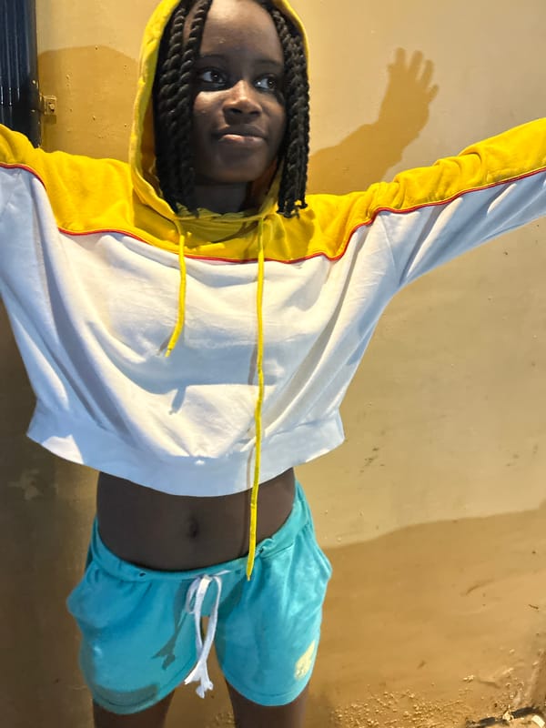 Youth in yellow hoodie captured in evening moments in Nigeria