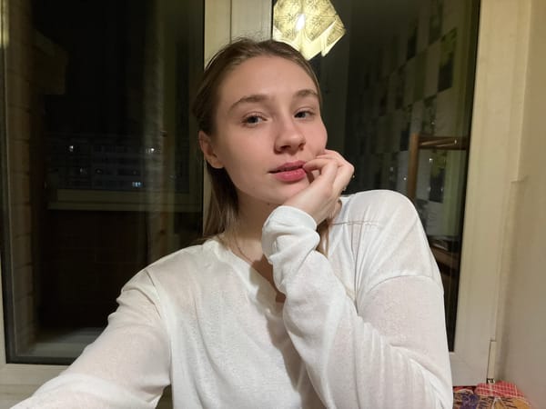 Woman takes evening selfies by window in Izhevsk