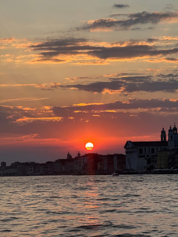 Venice at golden hour, canals and sailboats at dusk