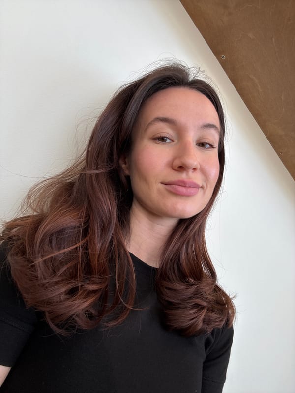 Woman photographed smiling in Tel Aviv indoor setting