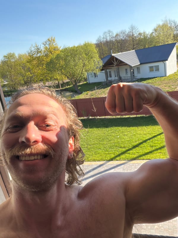 Man poses flexing for camera in Belarus countryside